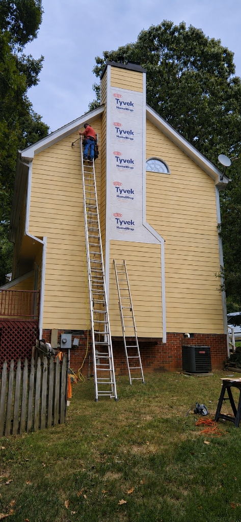 JBZ Owner on the job site working on chimney siding